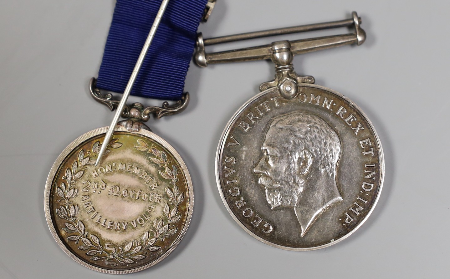 A Victorian Norfolk Artillery Volunteers silver medal and a WWI medal 319213 GNR. W. R. J. BULL. R. A.